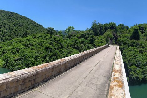 Cross the old masonry bridge